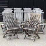 A set of twelve teak garden chairs and two others