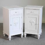 A pair of white painted bedside cabinets