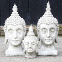 Three cast stone Buddha heads