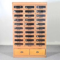 A mid 20th century haberdashery cabinet