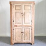 A 19th century pine standing corner cabinet