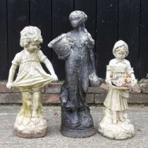 A cast stone black painted garden figure of a lady, 67cm high, and two others smaller(3)
