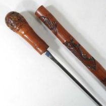 An early 20th century Eastern carved wooden swordstick, 88cm long