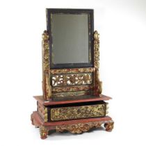 An Indonesian carved hardwood and polychrome painted dressing table mirror, with a single drawer, 41