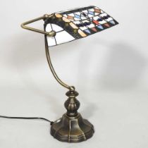A Tiffany style desk lamp, with a stained glass shade, 48cm high