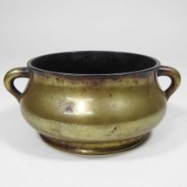 A small Chinese bronze twin handle censer, seal mark to base, 15cm wide overall Looks to have been