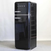 A black Smeg fridge freezer 60w x 63d x 168h cm