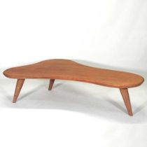A 1970's teak coffee table, of organic shape, on splayed legs 170w x 100d x 40h
