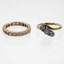 An 18 carat gold diamond illusion set three stone ring, of crossover design, size K, together with a