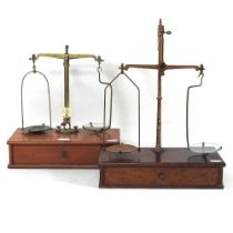 A set of early 20th century brass balance scales, 29cm wide, with weights, together with another