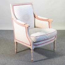 A French style cream upholstered bergere chair, on turned legs