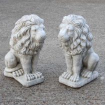 A pair of cast stone garden statues of seated lions, 58cm high (2)