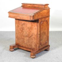 A Victorian burr walnut and in inlaid davenport, with a fitted interior, on turned feet 56w x 53d