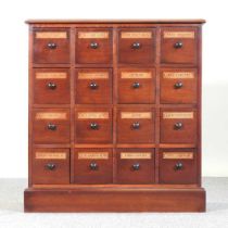 A handmade Victorian style apothecary chest, containing sixteen short labelled drawers, on a