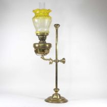 A 19th century brass adjustable oil lamp, with a yellow glass shade, 80cm high