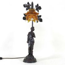 A bronzed figural table lamp, with a frilled amber glass shade, 53cm high