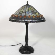 A Tiffany style metal table lamp, with a stained glass shade, 60cm high overall