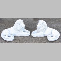 A pair of cast stone models of recumbent lions, 60cm long (2)