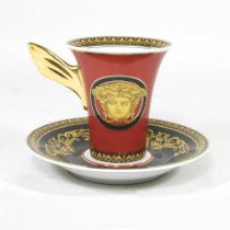 A Versace porcelain Medusa pattern tea cup and saucer