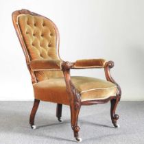 A Victorian gold upholstered button back armchair, on cabriole legs