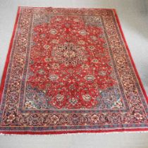 A Persian carpet, with central medallion. on a red ground, within multiple borders, 360 x 250cm