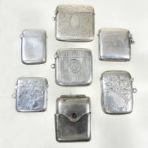 An Edwardian silver vesta case, with engraved decoration, together with five various silver vesta