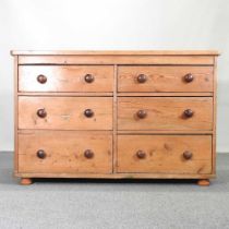 A large antique pine chest, containing two rows of short drawers 138w x 61d x 90h cm
