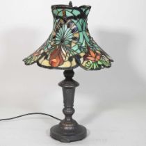 A Tiffany style metal table lamp, with a stained glass shade, 60cm high
