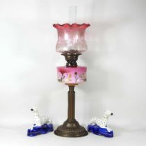 A Victorian oil lamp and shade, 60cm high, together with a pair of Staffordshire style dog