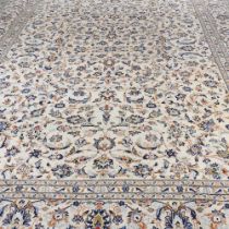 A large Persian carpet, with all over floral designs on a cream ground, 400 x 290cm