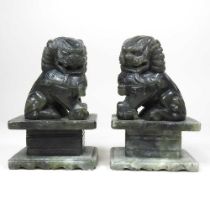 A pair of Chinese carved soapstone models of dogs, 16cm high