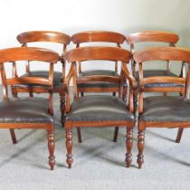 A set of six William IV style mahogany carver dining chairs, with brown padded seats, on turned legs