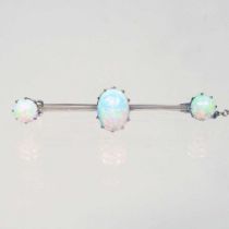 A 15 carat gold three stone opal bar brooch, with a pin back and safety chain, 3g, 42mm wide, cased