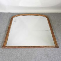 A large 19th century carved pine and gilt gesso framed over mantel mirror, of arched shape, with a