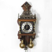 A Dutch wall clock, with brass weights, 48cm long