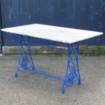 A painted metal sewing machine table, 122cm wide, with a granite top