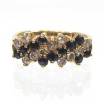 An 18 carat gold sapphire and diamond ring, set with six rows of alternating stones, 4.0g, size L