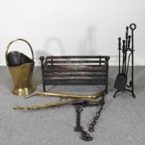 A cast iron fire basket, together with brass horse hames, fire tools and a coal bucket