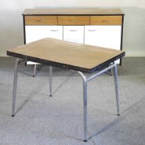 A 1950's laminated sideboard, together with a similar draw leaf dining table, on metal legs (2) 141w