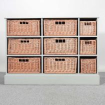 A green painted chest, containing nine wicker baskets 123w x 42d x 89h cm