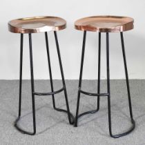 A pair of black painted metal bar stools, with copper plated seats, 76cm high (2)