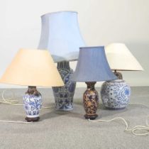 A blue and white pottery table lamp and shade, 80cm high overall, together with three others (4)