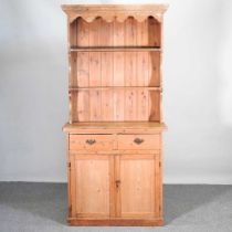 An antique pine dresser, with a boarded back and cupboards below 95w x 40d x 200h cm