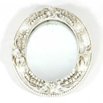 A Belleek porcelain framed easel mirror, of oval shape, stamped marks to the reverse, 28 x 23cm
