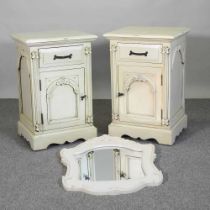 A pair of painted bedside cabinets, 46cm wide, together with a painted wall mirror, with a