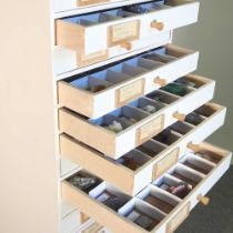 A painted collector's chest, containing eighteen drawers, containing mineral and rock samples 35w