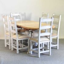 A modern painted and pine extending dining table, with an additional leaf, together with a set of