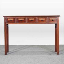 A handmade mahogany side table, containing five short apothecary labelled drawers, on square moulded