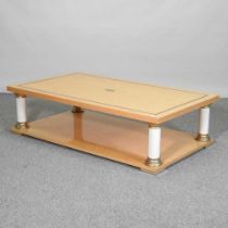A contemporary Italian Toro birds eye maple and brass coffee table, on column supports 130w x 75d