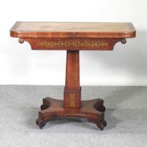 A Regency rosewood and cut brass inlaid folding card table, with a hinged D shaped top, on a